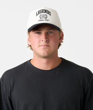 White baseball cap with black visor and "Legends Athletic Club" text embroidered on front.