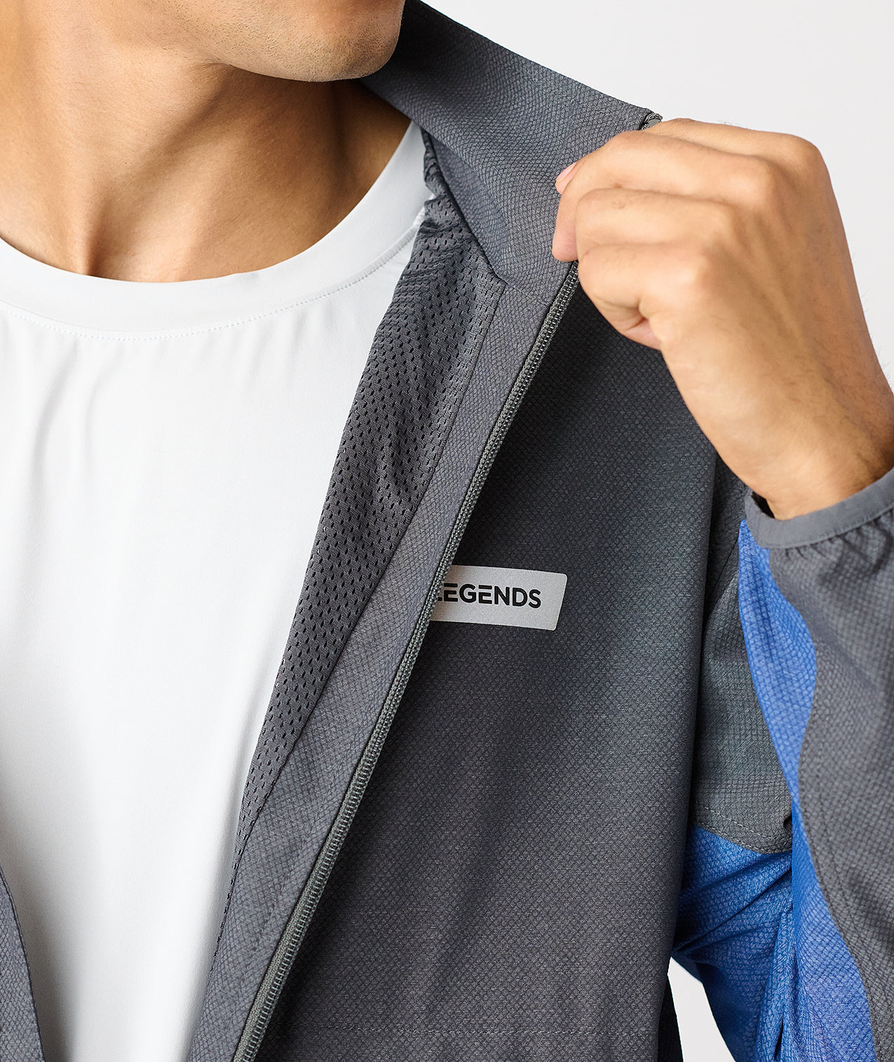 Charcoal full-zip jacket with textured fabric and blue accents, displayed unzipped over white shirt. - 7