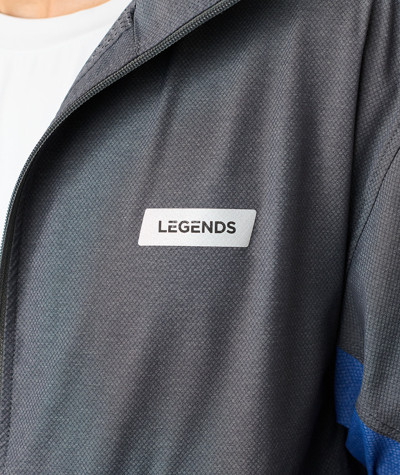Charcoal full-zip jacket with textured fabric, white "Legends" label, and blue panel visible on sleeve. - 5