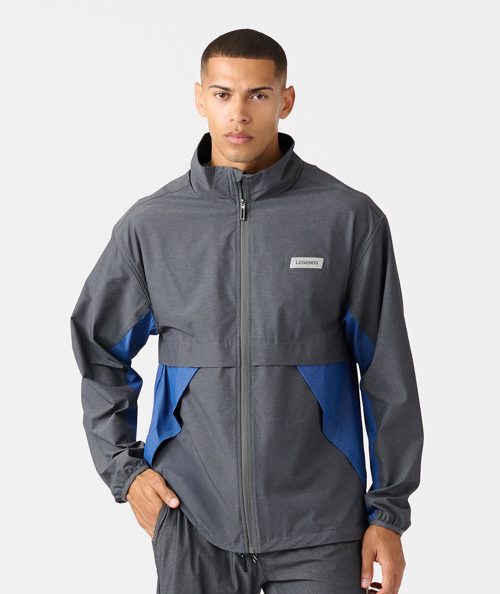 Charcoal and blue full-zip jacket with stand collar and color-block design on sleeves. - 1