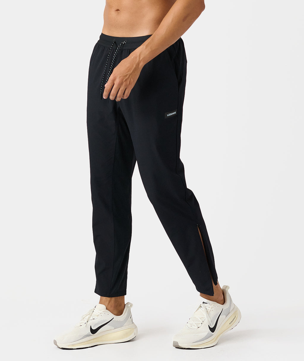 Black Luka HD pant with drawstring waistband, side pockets, and ankle zippers on male model. - 3